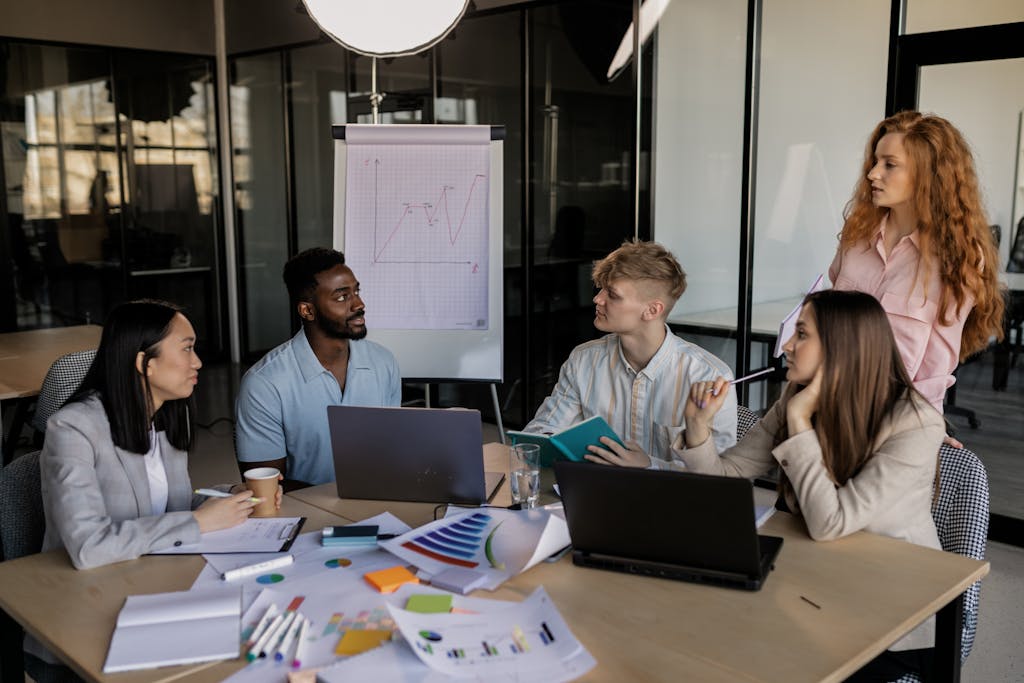 Team of young professionals collaborating around table